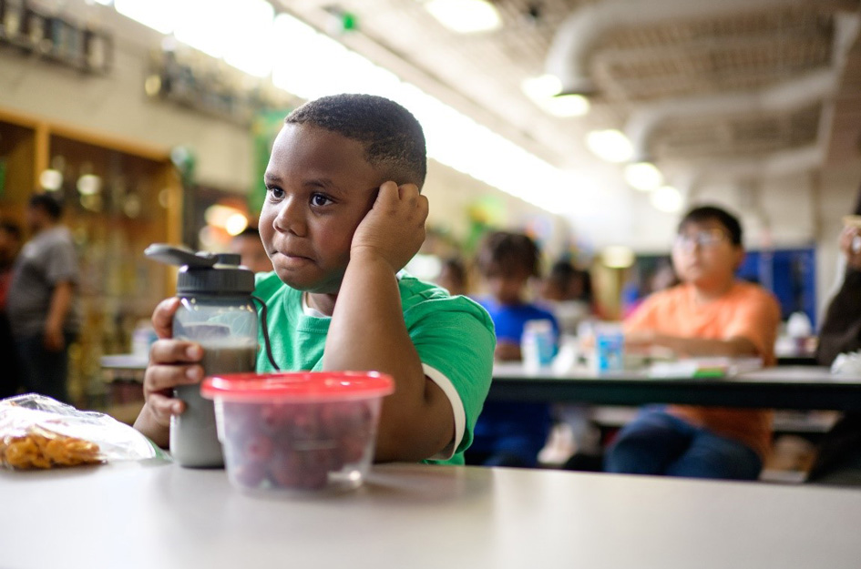 Pensive Club kid in cafeteria
