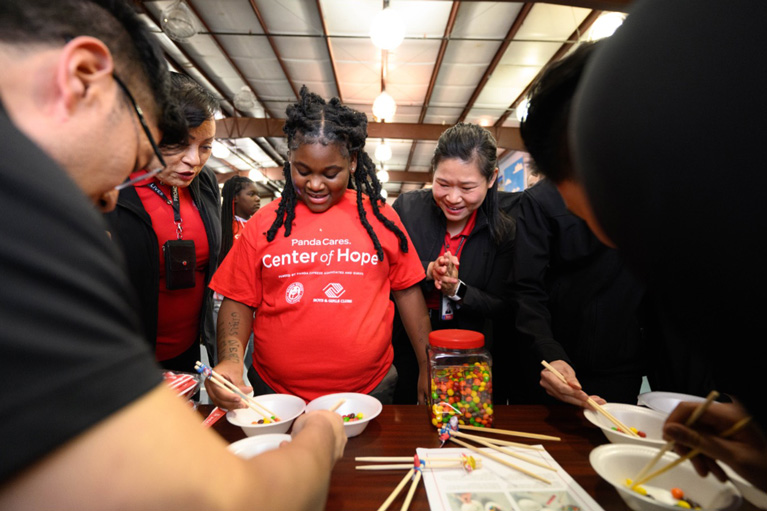 Club kid playing a game with chop sticks
