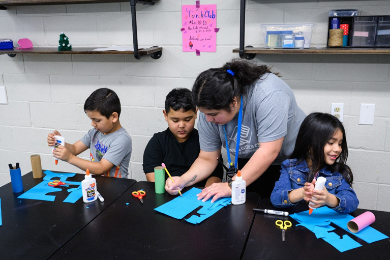YDP working on craft project with 3 Club kids