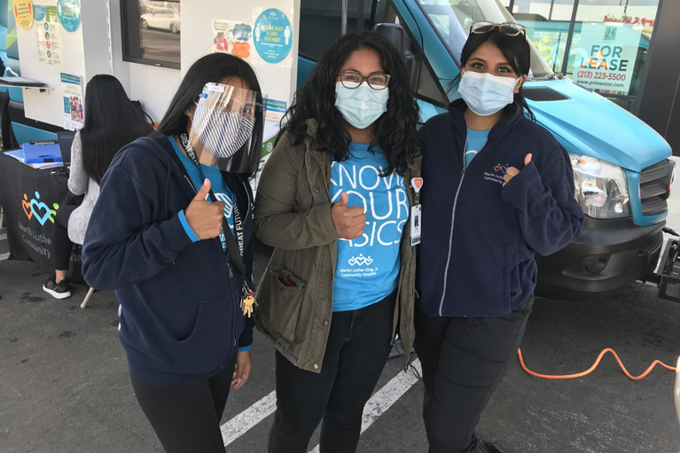 3 ladies in PPE with thumbs up