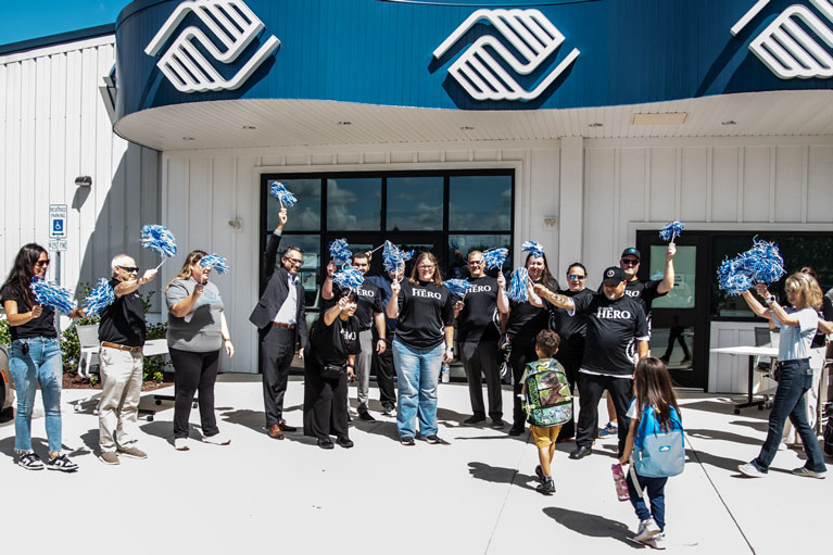 Caesars Foundation volunteers cheering Club kids entering the Club