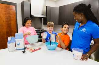 Club kids in kitchen cooking