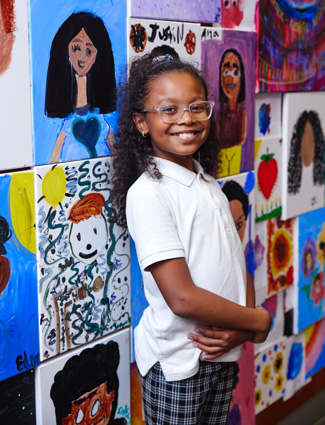 Club kid in front of art In honor of Hispanic Heritage Month