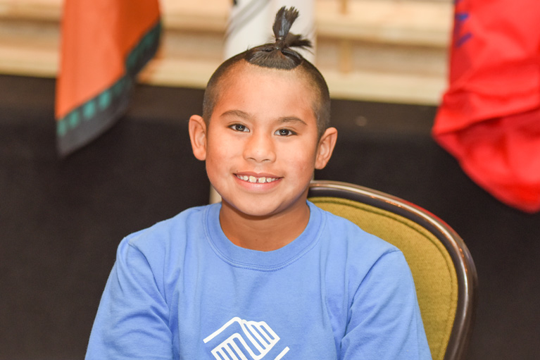 Native Club kid smiling at camera