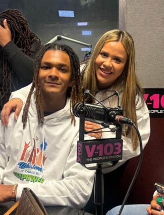 Jacob with Ms. Maria being interviewed at v-103