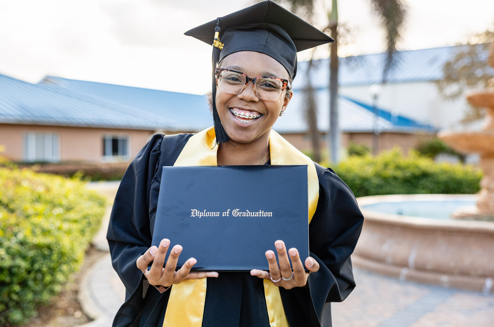 Teen graduate holding diploma