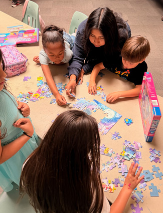 Nianti helping K-1 members with a puzzle