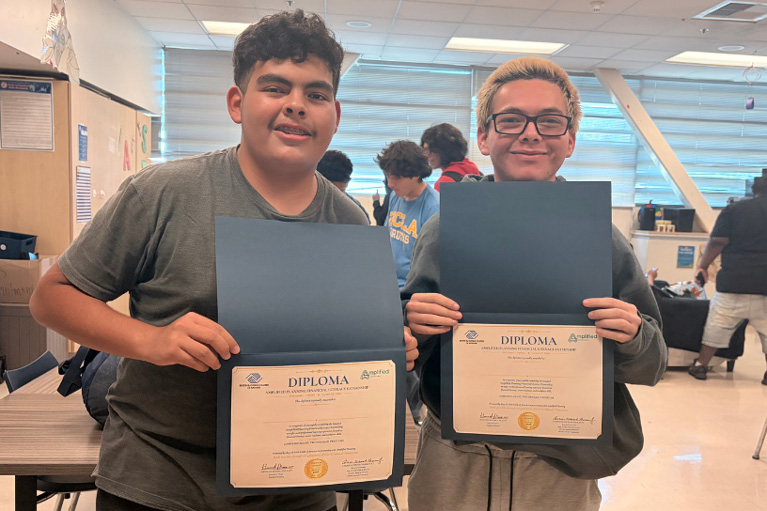 two The Externship Club kids with diplomas